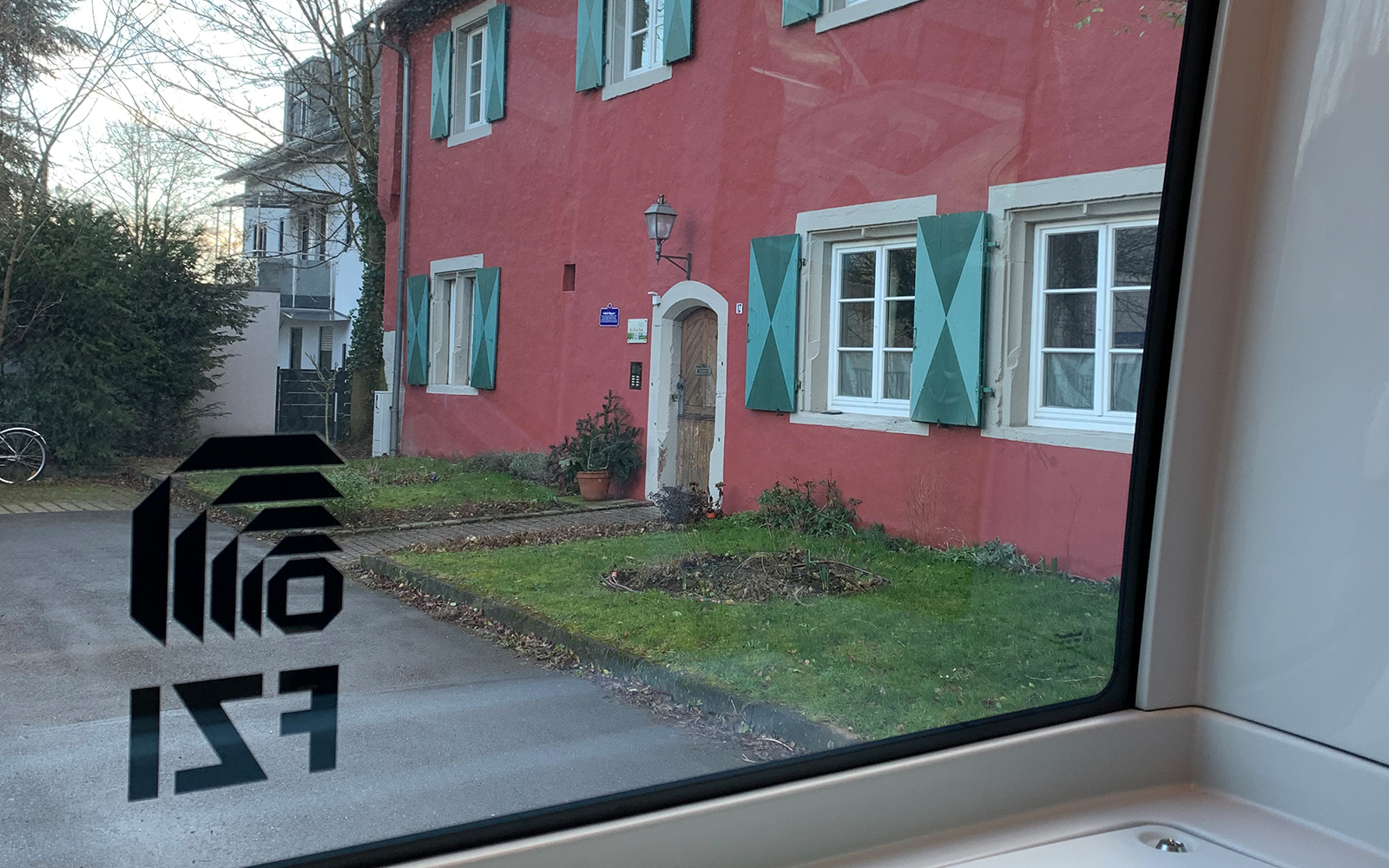 Bild aus dem EvaShuttle-Fenster auf altes Rüppurer Wohngebäude