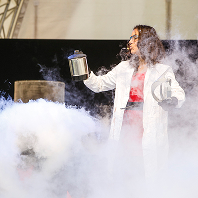 Science-Festival-Darbietung mit Forscherin im Arbeitskittel, Wasserkocher und viel Dampf
