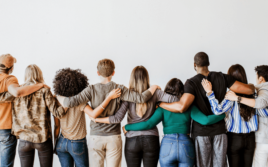 Menschen legen einander die Arme um die Schultern als Zeichen der Solidarität.